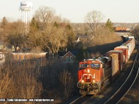 <b> GOOD MORNING SUNSHINE! </b> It's early on this Tuesday morning, as the sun is still rising and the morning silence has been broken. CN 2841 leads this eastbound freight winding it's way through Napanee, over the Napanee River and about to pass underneath the Palace Road bridge as it continues towards Kingston. Time approx. 6:50 a.m. 