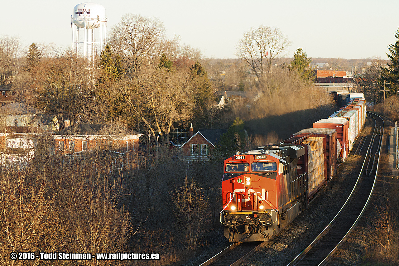 GOOD MORNING SUNSHINE!  It's early on this Tuesday morning, as the sun is still rising and the morning silence has been broken. CN 2841 leads this eastbound freight winding it's way through Napanee, over the Napanee River and about to pass underneath the Palace Road bridge as it continues towards Kingston. Time approx. 6:50 a.m.