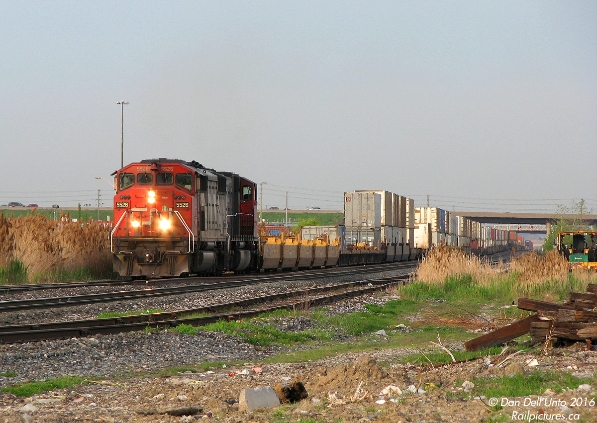 CN SD50F 5526 and SD75I 5785 motor west through "old" Peel on #149, fresh out of the Brampton Intermodal Terminal. The train stretches out in the distance, under the busy Highway 410 overpass that evening commuters zip home over without a glance down.

The small yard hidden on the right once held autoracks for the old AMC Brampton Assembly auto plant at Steeles and Kennedy, where the Peel Village Industrial Lead once ended. It still serves three remaining customers. Before Highway 410 was built decades ago, Heart Lake Road ran in its place over the tracks at a lowly crossing (parts still exist as a service road).