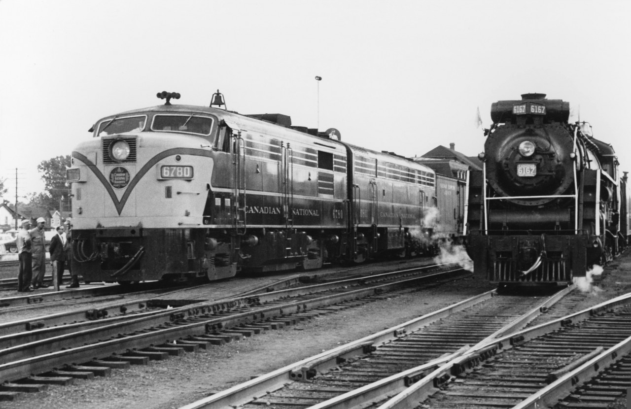 CN passenger train #114 finds a UCRS excursion powered by Nothern 6167 in Belleville near the station, on July 9th 1961. #114's power today is MLW FPA4 6780, and one of only a handful of CN 6800-series 5-axle C-Liner B-units trailing (an FM/CLC CPB16-5).