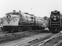 CN passenger train #114 finds a UCRS excursion powered by Nothern 6167 in Belleville near the station, on July 9th 1961. #114's power today is MLW FPA4 6780, and one of only a handful of CN 6800-series 5-axle C-Liner B-units trailing (an FM/CLC CPB16-5).