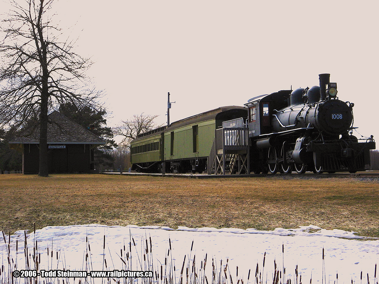 In the 1950's, the Government decided in an undertaking to widen the St. Lawrence River and make it part of the larger scale Seaway project. This meant most towns would be abandoned, and it's residents located to other nearby existing towns or newly created villages. Due to this decision, the CNR relocated it's trackage further inland. Most of it's original stations were demolished, and others were relocated. And still, new stations were built in a modern style of that time period. 
 
Today it has become known in history as the Lost Villages. Aultsville was no exception. A small town on the Seaway, it was one of the towns selected to be razed, and it's former lands flooded. The station however, was preserved and moved to this display just beyond Morrisburg at Chrysler Park. 

The display is visible from Highway 2, which also includes an engine 1008 and two cars. This pays homaeage to the train nicknamed the Moccasin. Interesting note...from Morrisburg, Highway 2  follows a portion of the original roadbed. The original stone station in Morrisburg, used to stand at the main intersection of Hwy 2 and County Road 1, now occupied by a shopping center.