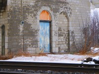 When the Grand Trunk Railway initially surveyed their Toronto - Montreal corridor, they had planned to build their line through the town of Bath. However, the decision was made to build the line 4-5 km north of Bath, and the town never got it's station.
<br>
Ernestown did get it's station. Built in typical GTR fashion of stone, it still stands the test of time. Although the trains ignore it's presence, Maintenance crews still used the station when I first visited the site as a kid in the early 80's. Shortly after, the crews left, the station was vacant and damaged by a fire that happened some years earlier. Still stands that way the day I took this photo. Still shows it's architectural detail as one of the few remaining stone stations left that were built in an era that showed prominence and detail, something that the railways of today will not be able to architecturally match. 