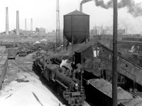 Not a diesel in sight! Steam still reigns supreme at Canadian National's Spadina roundhouse and shop facilities in 1952, as various sizes of steam engines from small switchers to big Northerns sit in downtown Toronto ready for their next assignments.
<br><br>
In the background, one can see various smokestacks (coal was the norm for heating) including those of the Central Heating Plant near CPR's neighbouring John St. Roundhouse. The White Rose gasoline signage in the background is on the roof of the Terminal Warehouse building, along the harbourfront.