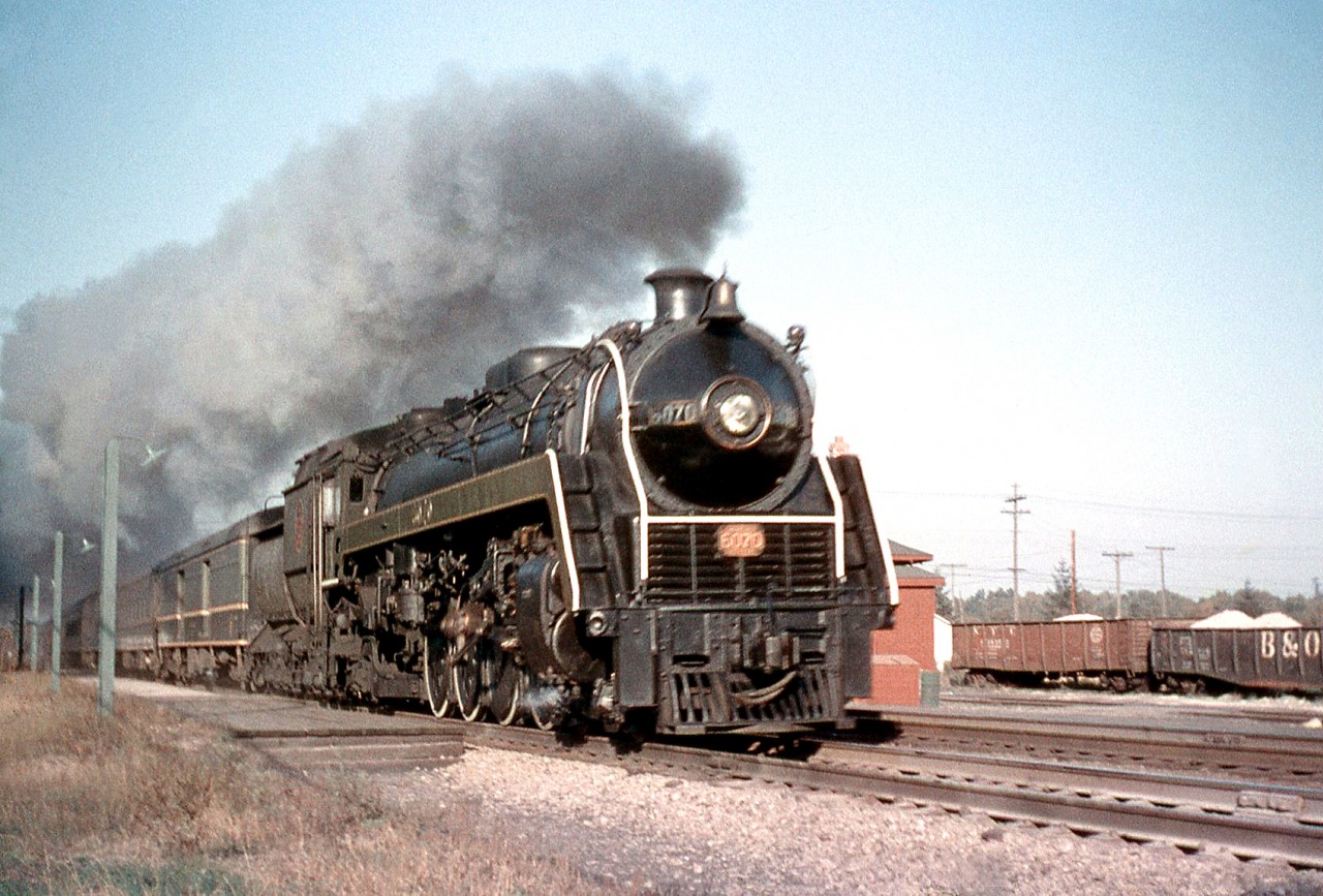 Leaving a good trail of smoke in her wake, CN “Bullet Nose Betty” 6070 (a U1f class 4-8-2 "Mountain" built by MLW in 1944) speeds past Port Credit Station in 1957 on the head end of a passenger train.