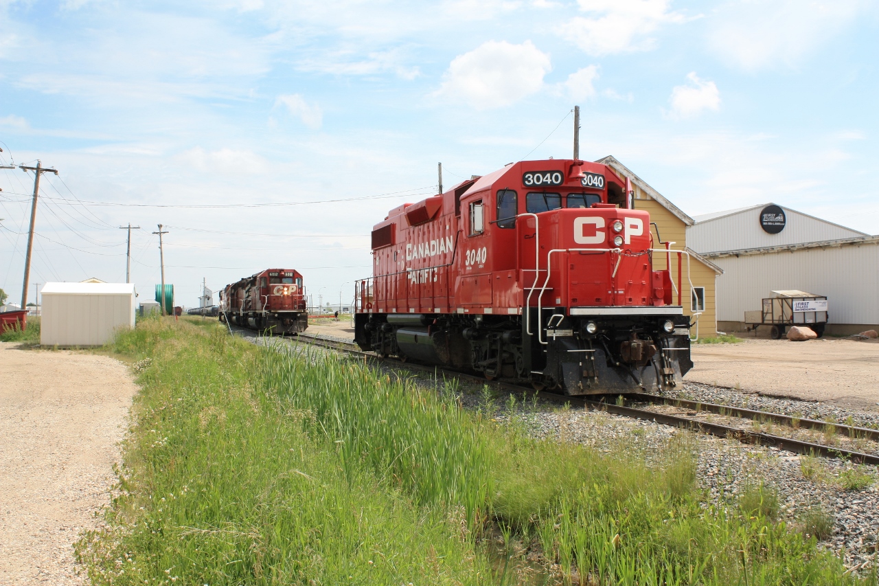 No shopping trip to Lloydminster is complete without dropping over to CP & CN yards and seeing what action is taking place. In this case I photographed CP 3040 sitting by the yard office. In behind CP 3040 were CP 6012, CP 6023, & CP 9008. The camera is pointed east looking into Sask. If I had backed up about 200 ft. I could have taken the shot from Alberta. Couldn't have asked for better weather! A slight breeze & no mosquitos.
