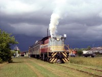 On August 1st 1991, the CRHA Annual Conference (in Kingston that year) traveled to Smiths Falls for a tour of the Railway Museum of Eastern Ontario. Former Canadian Pacific S3 6591 was operating on a short "excursion train" that day, and is shown running past the highway ahead of black storm clouds looming in the sky.