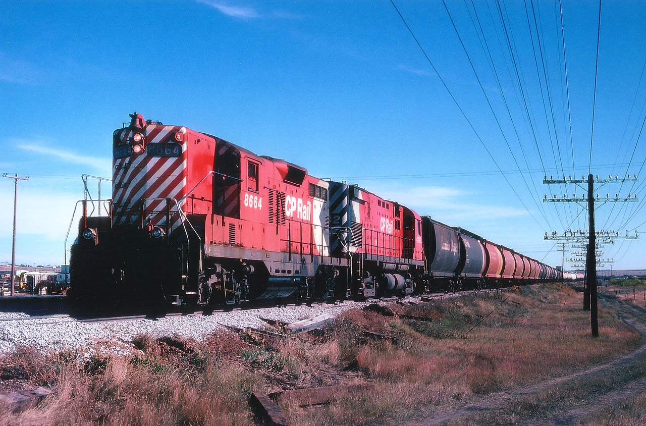 Just coming into Swift Current, heading west, is CP 8664 and 4242 with a long string of grain hoppers. The lead unit GP9 was eventually rebuilt to CP 1557 (GP9u) and then retired in 2012. The M-424 is currently on the Arkansas & Missouri, according to the CTG.