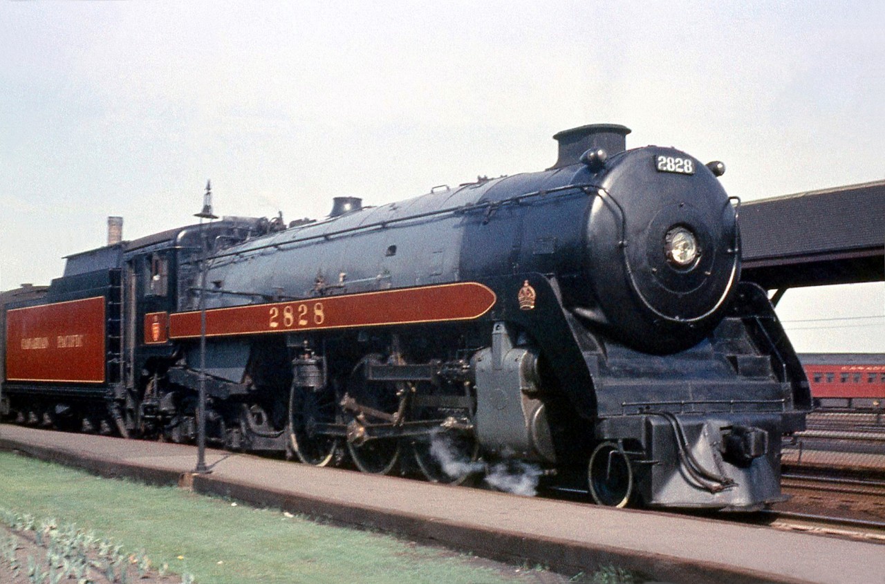 CPR H1c Royal Hudson 2828 stops at Montreal's Westmount station, enroute to Ottawa on a sunny afternoon in 1957. Built in 1937 by MLW for mainline passenger service and based out of the Glen Yard for most of her operating life, 2828 was scrapped the next year in October 1958, barely older than 21 years old.