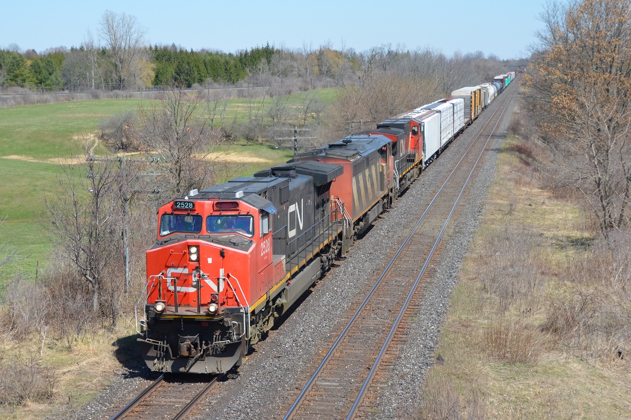 A C40-8M squished by 2 dash 9s lead train M385 towards Melrose diamond as it passes under Frank Lane at mile 6.7. Note the missing number board on the leader