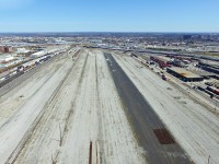 This was the first opportunity I'd take to fly over heavily restricted private property, and I almost got away with it. Except I found out I had actually driven onto CP property to fly it, and didn't even realize it! The maintenance worker was rather grumpy while informing me, but nonetheless allowed me to leave without the whole cop ordeal, which is good. While I did tell them I was flying a drone, I neglected to tell them I flying directly over their yard. Lol. Nonetheless, I gotta be more careful.  <br><br> This was one of the shots I took, and probably the ugliest one I got, in terms of what is shown. These were the hump tracks at CP's Toronto yard, and under the wrath of Hunter Harrison, the hump yard here and at many other CP yards were shut down. The hump yard closed, I believe, in early 2013, and was ripped in its entirety the next year. While Hunter is largely to blame for massacring the yard, it's an important reminder that cuts are a major factor in the private sector world today, and CP is not the only railroad closing yards, ripping up lines and laying off employees. Outsourcing and economic recessions surely have not helped either.  <br><br> The fate of this yard, besides the fact it is closed, is unknown. The north holding tracks could very well be shoved over towards the engine shops, and the rest of the land could be sold off for several millions of dollars. More optimistically, perhaps there is a brighter future ahead. Maybe one day, under a president less focused on stocks and more on railroading, this yard may exist again. However, the current ideology of class 1 railroads involve slow speeds, two to three mile long trains, and reclassifying of freight cars several times from origin to destination. Nonetheless, this makes it very hard to attract customers, and many have waved the rail industry goodbye because of this.  <br><br> That's probably enough ranting on my part. On the plus side, this vast area would make for a great rally race, and if the ground is solid enough, maybe a full on drag race. Just don't hit a pole or crash into the stacked rails. Take notice Hunter, you could make a lot of money off of this. Of course, the only way this would likely happen is illegally. Unlike some U.S (Oakland) foreign continent cities, illegal racing and sideshows are pretty rare here, even in Toronto's sketchy parts like this one. Lets keep it that way.  <br><br>  NOTE: Only the hump yard is closed. Many of the classification tracks and the engine shops at Toronto yard are still very much active.