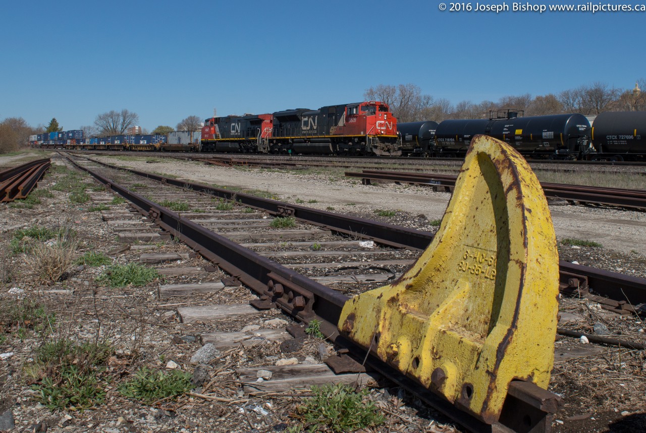 CN 148 rolls through Brantford behind CN 8809 and BCOL 4647 on a sunny April morning.