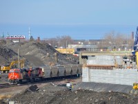 <b>A lot of infrastructure work.</b> CN B730 with 152 loads of Potash destined for Saint John, NB is slowly starting to leave Turcot West in Montreal after changing crews, with the previous crew visible at left, about to inspect the train as it leaves. Power is a trio of ES44AC's, with CN 2934 & CN 2812 at the head end and CN 2940 bringing up the rear. The train is passing a lot of infrastructure work.