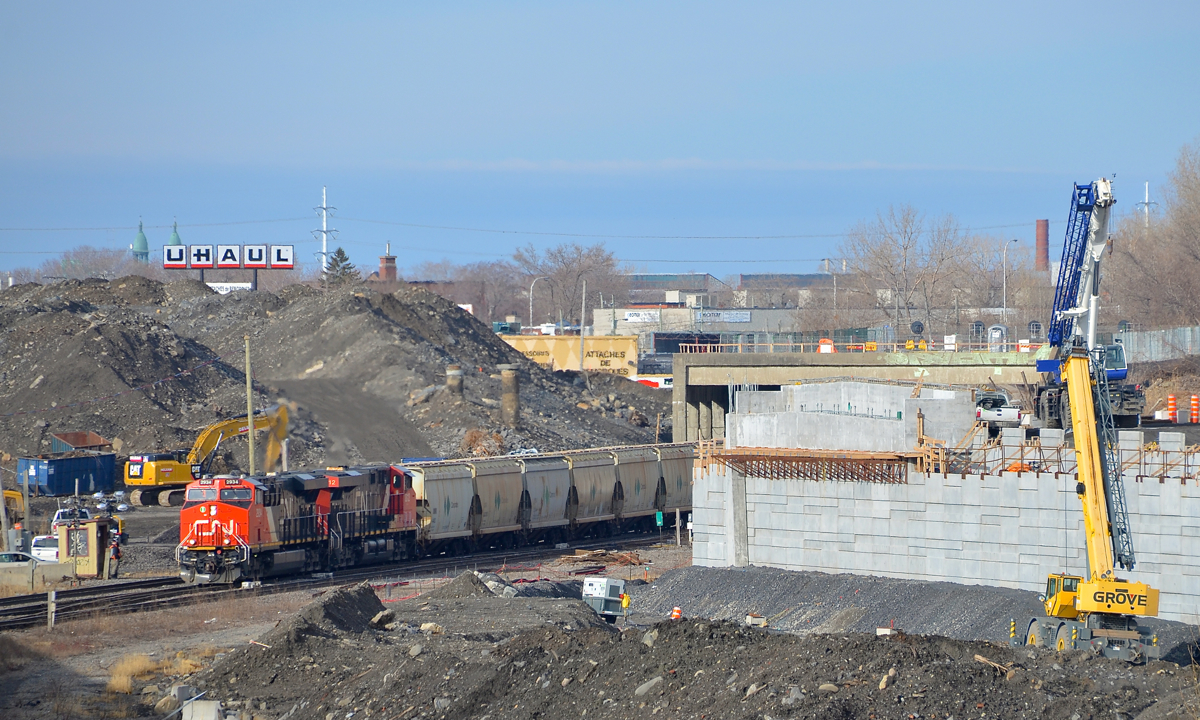 A lot of infrastructure work. CN B730 with 152 loads of Potash destined for Saint John, NB is slowly starting to leave Turcot West in Montreal after changing crews, with the previous crew visible at left, about to inspect the train as it leaves. Power is a trio of ES44AC's, with CN 2934 & CN 2812 at the head end and CN 2940 bringing up the rear. The train is passing a lot of infrastructure work.