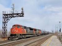<b>DC power on CN 377.</b> CN's newer AC power (GE ES44AC's and ET44AC's) is commonly found on CN 377, but here two slightly older DC units (SD70M-2 CN 8819 and ES44DC CN 2284) lead CN 377 through Dorval just as the sun cooperates on a partially sunny afternoon.