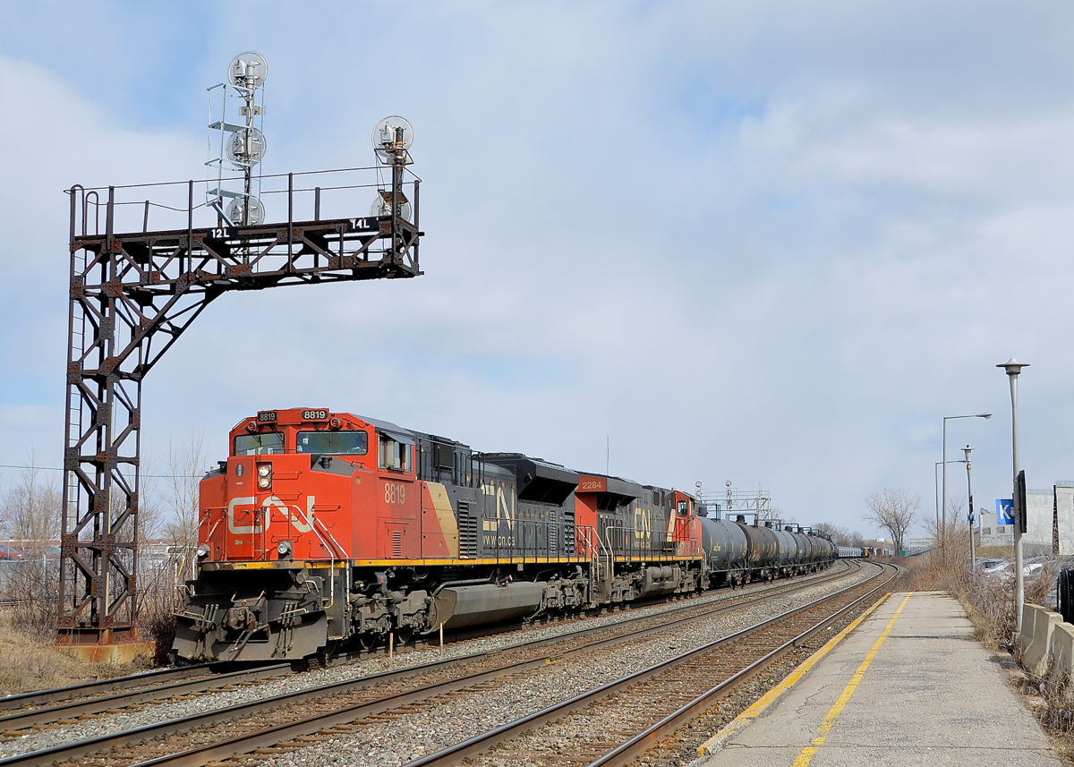 DC power on CN 377. CN's newer AC power (GE ES44AC's and ET44AC's) is commonly found on CN 377, but here two slightly older DC units (SD70M-2 CN 8819 and ES44DC CN 2284) lead CN 377 through Dorval just as the sun cooperates on a partially sunny afternoon.