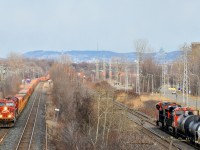 <b>CP westbound, CN eastbound.</b> As I start shooting CP 143 on CP's Vaudreuil sub at left, a slightly earlier than usual CN 376 pops into the frame at right on CN's parallel Kingston sub. Both trains are powered by GE products - CP 143 is westbound with ES44AC's CP 8851 & CP 8727, while CN 376 is eastbound with ET44AC 3008 and ES44AC CN 2874.