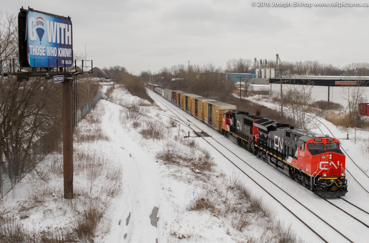CN 394 approaches CN Masseys with CN 3049 and CN 5703 leading a long train.  3049 is about a week into revenue service on CN and is from the second batch of GE ET44Ac's that CN has on order.  Noteworthy about this order is the boxy looking hump towards the rear of the unit has been remodelled to blend into the shape of the unit nicer.  Guess that makes the first ET44's on CN to be 'unique' units.  If anyone wishes to see a close up roster of 3049 to study the differences let me know!