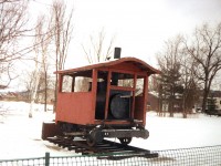 This 0-4-0 was built as a steam dummy by Baldwin in 1879 for the Hamilton & Dundas Street Railway. It ended up working for the Beck lumber Co. in Penetanguishine. It was later cosmetically restored without the body and an enclosure was built around it.