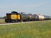 The Essex Terminal is a railway that hasn't had had vast amounts of coverage on this site, so I thought I'd add to the catalogue. Seen here is ETR 105 pulling 9 tank cars south towards Amherstburg, roughly 15 km south of Windsor. Their destination is about 5 km south of here along Thomas Road, where they will shove their train into the former General Chemical property to reach Honeywell, who manufactured hydrofluoric acid. The crew will drop the last 6 cars at Honeywell then take the first 3 tankers-full of Crown Royal Whiskey from Gimli Manitoba-to Diageo at the southern most point of the railway.

Today Honeywell is closed, shuttering operations in 2013, and this local has been reduced from a daily run to 1-3 trips per week. The ETR has lost a ton of freight over the past 10 years, losing 4 of their largest customers since 2006. There were 5 customers in Amherstburg 10 years ago, now only 1 remains. 