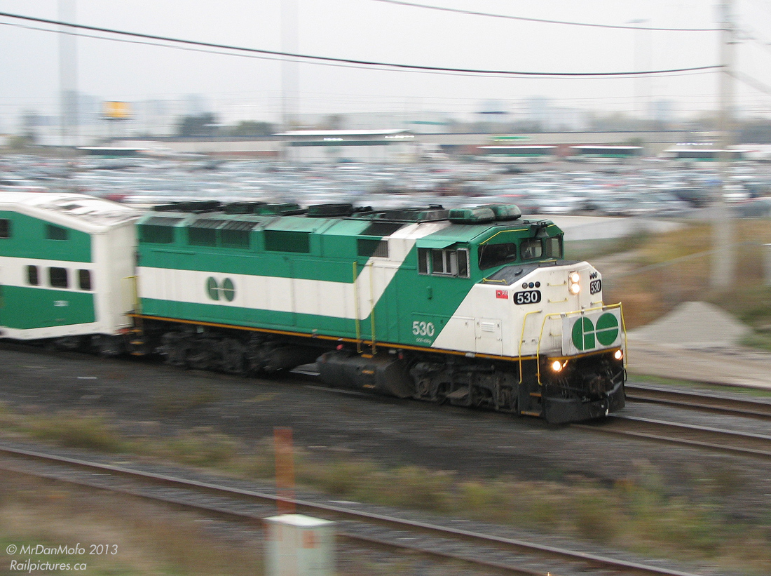 Bringin' it Back on Home.

After dumping the last load of #281's afternoon commuters at downtown Brampton, GO Transit F59PH 530 is done her day's work on "The Bramalea Flip", and motors through Bramalea GO station express-style with equipment move #864 deadheading back to downtown Toronto.

The photographer had popped off the train at Bramalea (one stop before the end of #281's run) and decided to stick around and hike up the overpass for a returning shot. The train is about to duck under Bramalea Road on the south track of the Halton Sub, and enter the Weston Sub at Halwest.