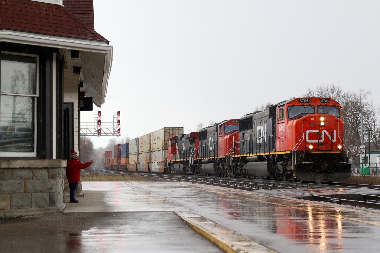 There are times that we can almost feel burnt out with a passion that we hold dear. the railroad industry is constantly changing and over the last several years that has meant loosing a lot of the motive power I grew up with, as well as loosing many trains I used to chase regularly. Starting a family also cut back drastically the distances I once traveled just to photograph my favourite trains, not that I would change anything because now I have two amazing little railfans :) We sometimes have to see the excitement in a child's eyes to renew our passion in something that was once so dear to us. March 17, 2016 was just another dreary wet winter's day, but my boys wanted to go rail fanning none the less, and I certainly couldn't say no. Georgetown has been a long-time haunt for me, so this would be our destination this day. Knowing that CN stack train 148 was on it's way we held up in the warmth of the car until we could hear a horn blowing for a distant crossing then ran for the cover of the old one time Grand Trunk station. The sight of a pair of SD75s and a Dash-9 did little to excite me, until I saw the excitement in my son Christian's eyes as the train did a horn salute for him, forcing me to briefly brave the down pour to catch the moment. Suddenly the so called boring power wasn't so bad after all, especially in days of endless lash-ups of GEVO's. Thanks to my boys for renewing my passion.