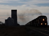 CP EMD's roar past the old grain elevator at Mossbank on its way north to Moose Jaw with 65 loads.