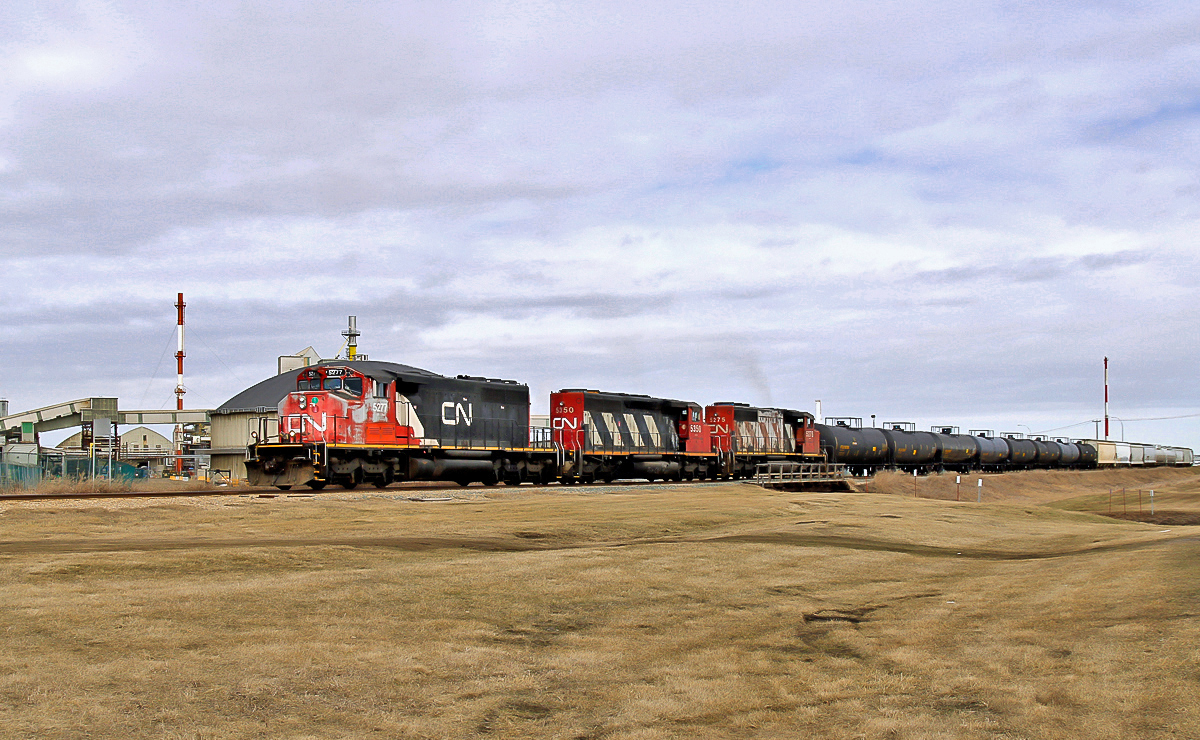 A trio of SD40-2(W)'s switching on the Fort Saskatchewan Industrial Lead. CN 5277, 5350 and 5275 had pulled a very long line of cars from the Dow Chemical Plant sidings and had come down to within a couple of hundred meters of the end of track at the city end.  Now seen pushing back to the Scotford Yard, 4 1/2 miles away.