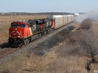 With highway 401 closed in both directions through Milton due to a truck roll over I was forced to head south of town. CN trains 551 and 382 were block on block so I chose the new Louis saint Laurent bridge to catch the action, unaware of excitement to come. I missed 551 by a couple of minutes but soon noticed numerous small fires winning the roadbed through town set by a sparking wheel set. I soon figured 382 would be held at Ash until the fires were extinguished, but I was quickly surprised by a headlight breaking through the smoke, fanning many of the fires. It wasn't long before the bridge was packed with curious observers.