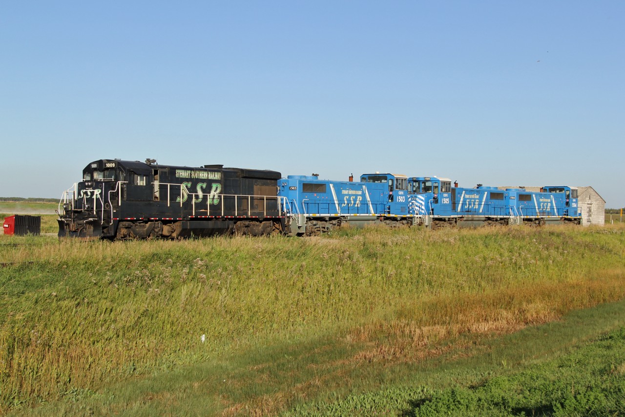 Stewart Southern Railway B23-7 1009 along with leased CEFX GP15Ds 1503, 1505, and 1504 parked in the siding at Fillmore.