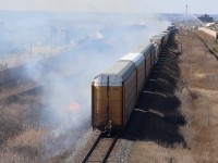 The passage of CN local 551caused numerous fires through Milton thanks to a sparking wheel set. CN 382 was lined on its block and chose to try to make it through town before the fires got worse. The train ended up fanning the flames covering much of the town in smoke, as the fire department tries to battle one of the larger fires in the distance.