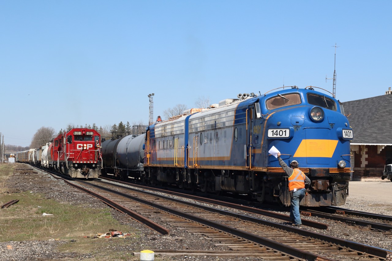 "Hooping" orders was once such a common sight in railroading, and apparently it is still needed even in today's modern world. A westbound local briefly stops at Woodstock, while the daily Ontario Southland run switches cars at the interchange. The mix of multiple generations of EMD locomotives here was also a nice change from the countless number of GE locomotives that usually pass through town.
