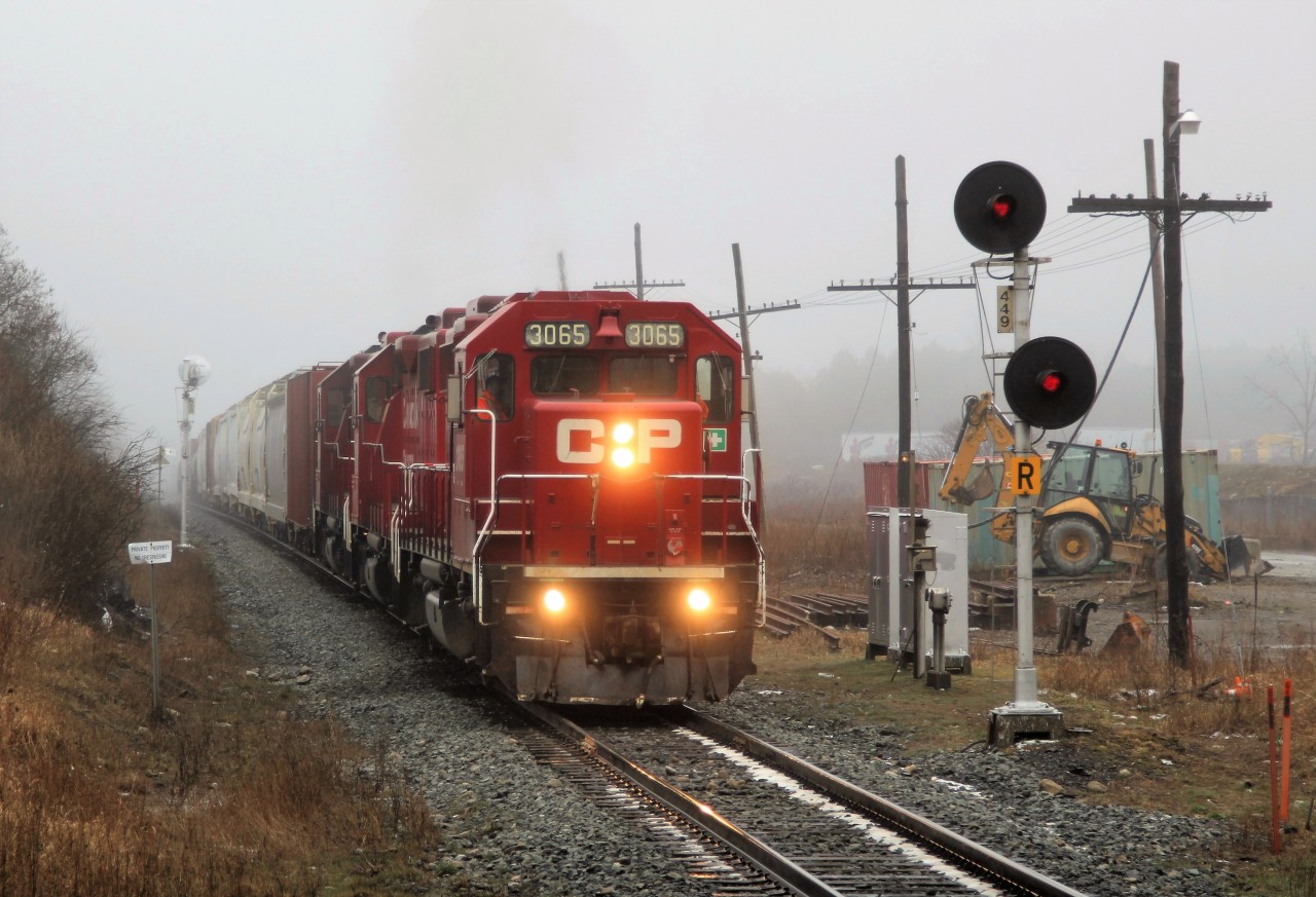 After waiting for CP 2259 to pass down the Puslinch siding, todays pickup train is lead by a trio of GP38AC's for power with CP 3065 on point and CP 3061 and CP 3130 helping out, as they make their way under the highway six overpass and past signal 449. A lot of construction gear and storage units have been brought in lately to this location for work on the signals and crossings down to Guelph Junction.