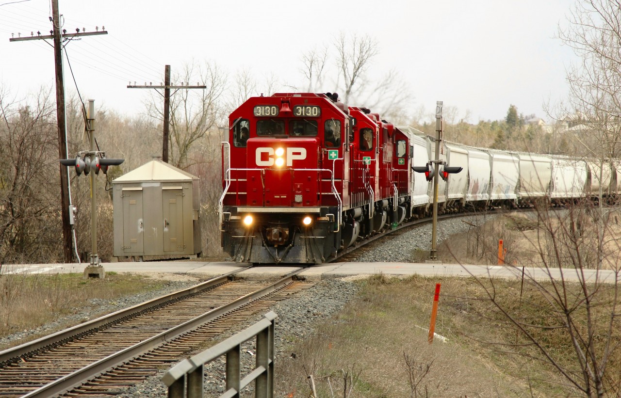 This one doesn't quite make the time machine but shows what the Victoria Road crossing looks like now in comparison to Mr. Mooney's RP submission photo from 1998 (24140)he submitted last week. The only real additions apart from the trees being taller are the guard rails on the bridge over the creek and the signal bell is no longer the round style. Oh and of course, we probably won't find power like his around here any time soon!!. The daily pickup with its trio of GP38AC's provides the power with CP 3130 on the lead.