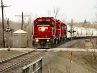 This one doesn't quite make the time machine but shows what the Victoria Road crossing looks like now in comparison to Mr. Mooney's RP submission photo from 1998 (24140)he submitted last week. The only real additions apart from the trees being taller are the guard rails on the bridge over the creek and the signal bell is no longer the round style. Oh and of course, we probably won't find power like his around here any time soon!!. The daily pickup with its trio of GP38AC's provides the power with CP 3130 on the lead. 
