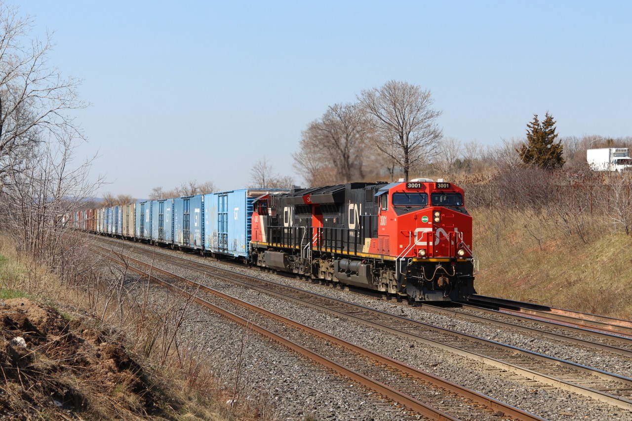 Two of CN's newer locomotives, CN 3001 and CN 3002,  power todays very short CN 562 up to MM 35.5 and prepare to go under the Lemonville Road overpass.