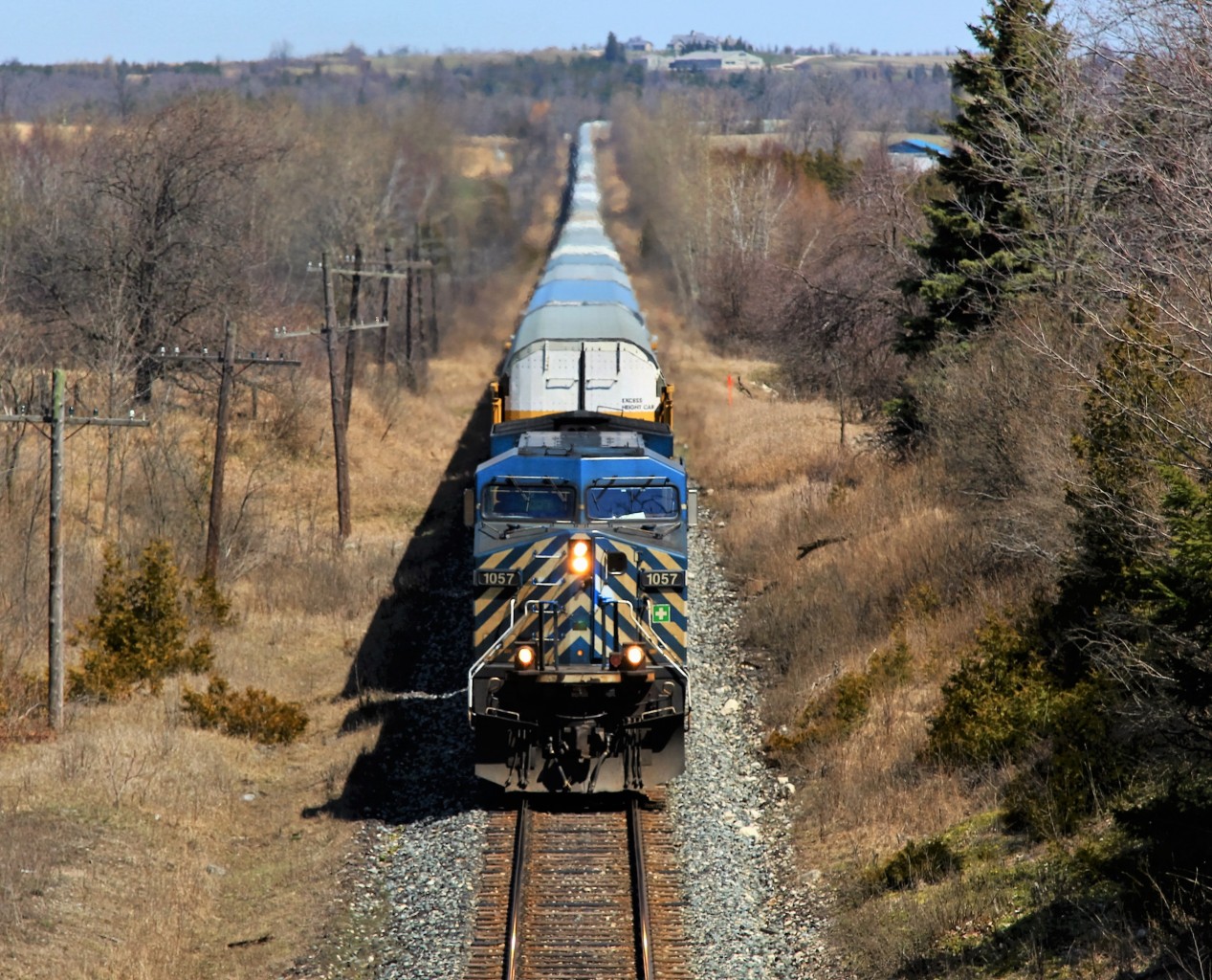 A lone CEFX 1057 works extremely hard to haul this 6000ft plus load of auto racks up the grade as it prepares to go under the Highway 6 overpass and MM45 on the Galt sub. This is a good vantage point for shooting trains but not the best of spots at this time of day for traffic biting at your coat tail.