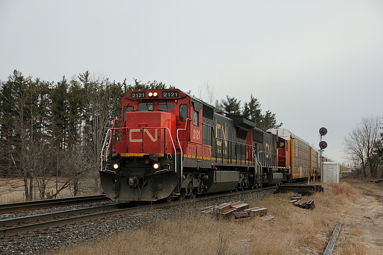 After a clear to stop signal appeared at the west end of Georgetown, we moved to try and find a better spot to shoot this thing. A foreman at Mile 22 called out the lead engine number; "CN 2121 west, passing red flag at Mile 22 Halton Sub, on the North Track." So I became a little more excited about shooting this.