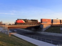 Canadian National SD70M-2 8018 brings up the rear of hotshot intermodal Q102 as they are nearing the end of their journey, passing Thornhill, Ontario as they slowly (but quickly in the photo) creep up to a slow order at CN Snider.