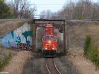 Canadian National intermodal Q121 struggles with 2 GEVO's in a 1x1 setup as it climbs up the York Subdivision at CN Beare. Over top passes the Canadian Pacific Belleville Subdivision.