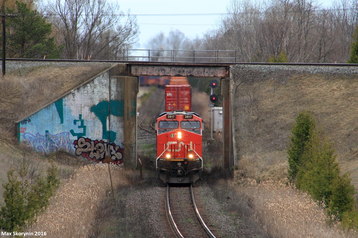 Canadian National intermodal Q121 struggles with 2 GEVO's in a 1x1 setup as it climbs up the York Subdivision at CN Beare. Over top passes the Canadian Pacific Belleville Subdivision.