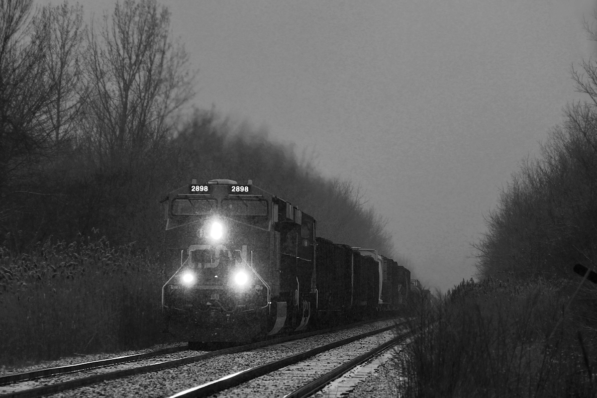 Chasing a pair of GEVOs has never been on my list of things to do, however, the blizzard on April 3rd got me chasing CN 330 from St. Catharines to Port Robinson. Something seemed particularly somber about this trip, but I never thought much of it. This would be the last CN 330 I may ever see, as it and its counterpart 331, were cancelled on April 6th, 2016. Here it passes Garner Road in Niagara with CN 2898 and 2829.

CN 330 began as a Buffalo-Toronto freight, with its counterpart 331 running the opposite direction. In the early 2000s they were rerouted out of Sarnia. By early 2008, the two trains were stubbed from Buffalo to Fort Erie. The 2008 recession mothballed them, and their remaining cargo was put on 338, 339, 421 and 422. They returned in October 2009, being stubbed further to Port Robinson, which seemed positive enough. However, shortly afterwards, 338 and 339 were slashed and have been gone since. CN added 232 as a relief autorack train to run as required, however rarely ran and still rarely does. Otherwise, things largely stayed the same until April 2015 when CN stubbed 421 and 422 from Fort Erie to Port Robinson, transferring all remaining marshaling operations there. The length of CN 330 and 331 had been in question ever since the St. Thomas Ford plant closed, meaning it no longer hauled autoparts cars from there, but especially more recently as they have constantly hovered around 50 cars.

CN 421/422 will no doubt have difficulty hauling 330/331's traffic, as both trains are already typically 130-160 cars long. Perhaps CN 232 will see more frequent usage, as well a possible counterpart train introduction for when 421/422 cannot handle all the traffic. Nonetheless, with GO Transit now pushing to buy the Grimsby Sub, it seems relatively predictable that CN could reroute its remaining traffic to the CP Hamilton Sub, especially with all the rumours going around this may occur, which was before GO even took great interest. As of now, the CN Grimsby Sub sits at four trains a day, Via 97/98, and CN 421/422. Just skeletons of what existed as recently as 15 years ago. It's sad to see, but Niagara is just one of many places between Canada and the U.S that has had this happen.