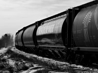 Frozen Saskatchewan hoppers head for home rails as they are 3 miles west of Saskatoon on the Rosetown with roughly 20 to go before hitting Delisle.