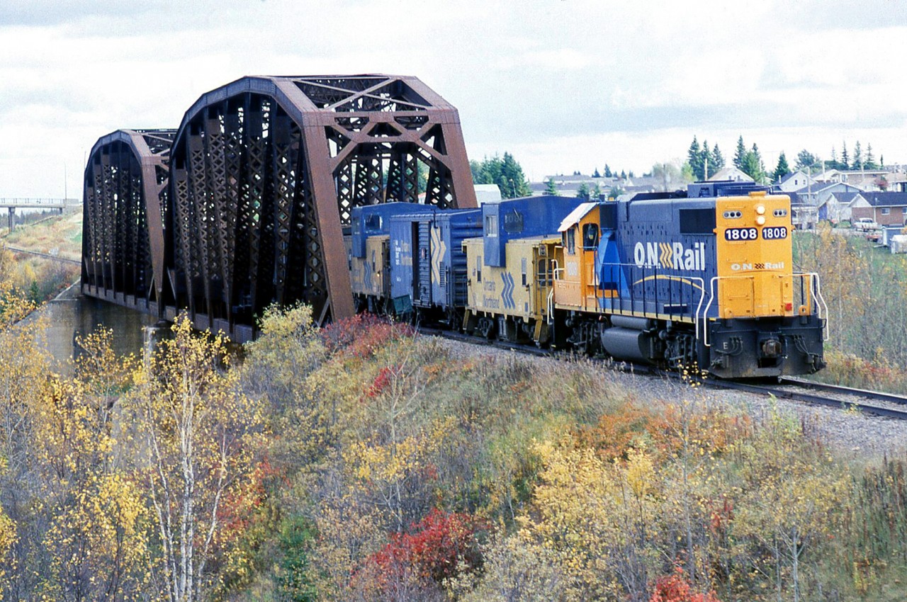Ontario Northland GP38-2 1808 is leading a westbound freight running long hood forward, crossing the Groundhog River bridge at Fauquier Ontario enroute to Kapuskasing. ONR acquired the 129-mile long Kapuskasing Sub from CN in 1991.