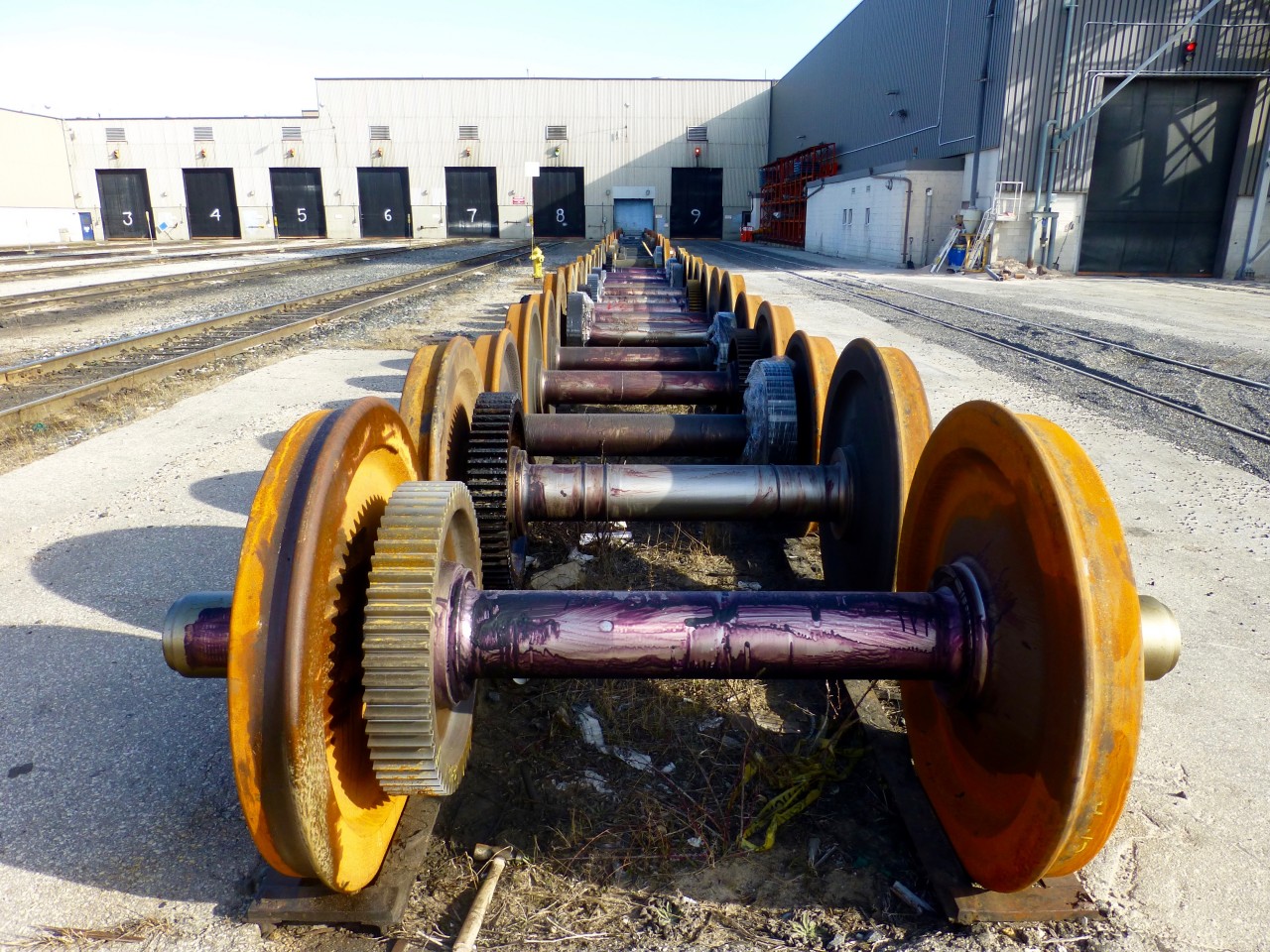 Need some traction? A line up of locomotive wheel sets sit outside the diesel shop at MacMillan Yard in Vaughn on a cold April morning. The gear attached to the axle along with gears in the traction motors themselves will decide the gear ration and thus the top speed of the locomotive. 62:18(62 gear teeth mated with 18 teeth) is the ratio for a locomotive with a top speed of 65MPH