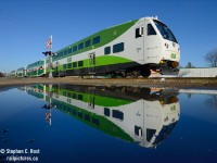 And another in the reflection series.. I really enjoy how the GO colours contrast the beautiful blue sky day... we've just finished 10 blue sky days in a row (rain for next two days). I never thought that I'd say that the new GO scheme looks good, but this does look good to me.<br><br>
I'd love to duplicate this photo with some other GO equipment.. but the puddles evaporated days ago :)<br><br> BTW for any of the Metrolinx or related companies viewing this (I know you are out there and that you do browse this site on a regular basis!) I can license this photo to you if you like :)  Our photographers are very willing to license their work, don't hesitate to contact them today!
<br>



