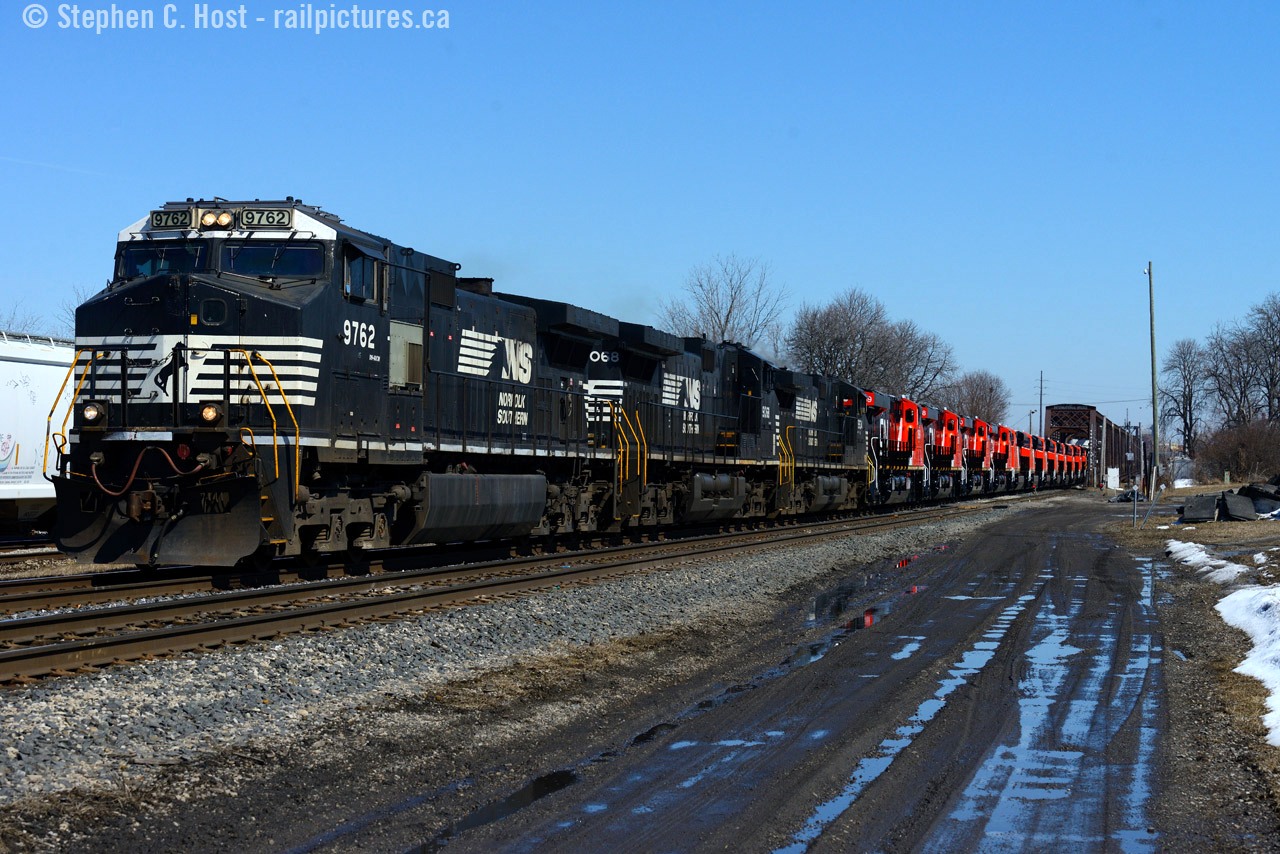 Zoom out.... zoom out... zoom out.. keep zooming.... almost.. SNAP!
That's what it was like to get all 15 locomotives on this train in a single photo. It wasn't easy and all the while the local constabulary (parked behind me, no room to walk further back) had a discussion with us just as the train was coming across the bridge. Since we meant no harm they didn't say boo and we took off for  Duff for the next shot. This is yet another operation that continues to operate in 2016... that baffles the mind. A four man crew of the NS St. Thomas, Ontario division, the last of "The Canadians" in the Buffalo terminal, also known as the Wabash men.