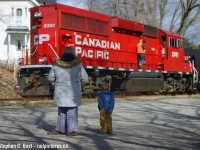 <b>Making memories in Inglewood</b> A young child is surprised by the sight of a shiny red CP engine while RP.CA member and contributor <a href=http://railpictures.ca/author/runeight target=_blank> Steve Bradley</a> is seen heading back to the cab to continue the trip to Streetsville. I don't think this kid will forget it!

