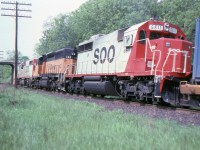 [Editors note: MILW paint rare on CPR] A few months before this photo was taken, SOO Line took over much of the eastern part of the bankrupt Milwaukee Road. A number of locomotives were included in the deal and here we see MILW SD-40-2 142 still in full Milwaukee paint between SOO 6615 and 6611. The train is westbound approaching the Elgin Street bridge at mile 164 Belleville Sub.