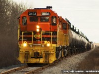 Prior to this photo, I had made many attempts at photographing this train in it's daily activities...either switching at Imperial Oil facility, or trying to capture it as it trundles up the line to the Garnet yard. However, either poor lighting, extreme weather conditions, or just not enough time all proved to be the barriers that prevented me from getting a good shot.
<br>
It was my first attempt when on a cold and blustery day after Easter, I chased the train as it departed Esso, and went up a few concessions where I stood at the railway crossing and waited...and waited...and still waited. At this pint, standing at the crossing near open fields and feeling the windchill of that afternoon, I came up with a nickname for the Southern Ontario Railway - just like they used to do in the golden days. I christened it "Slow but Operational" on this 1.75 mile stretch to the Garnet yard.
<br>
All things considered, my timing was perfect this day as I finally saw SOR 3404 in the lead with 3403 behind it pulling a string of tanker cars from the Imperial Oil facility to the Garnet yard. 